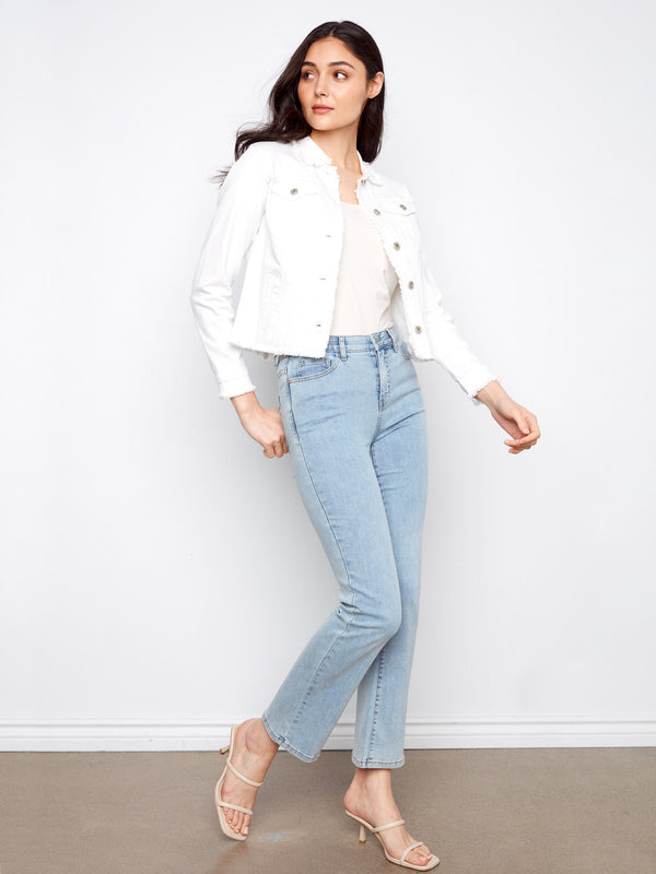 Frayed edges add an edgy touch to this versatile white jean jacket with button closure by Charlie B.