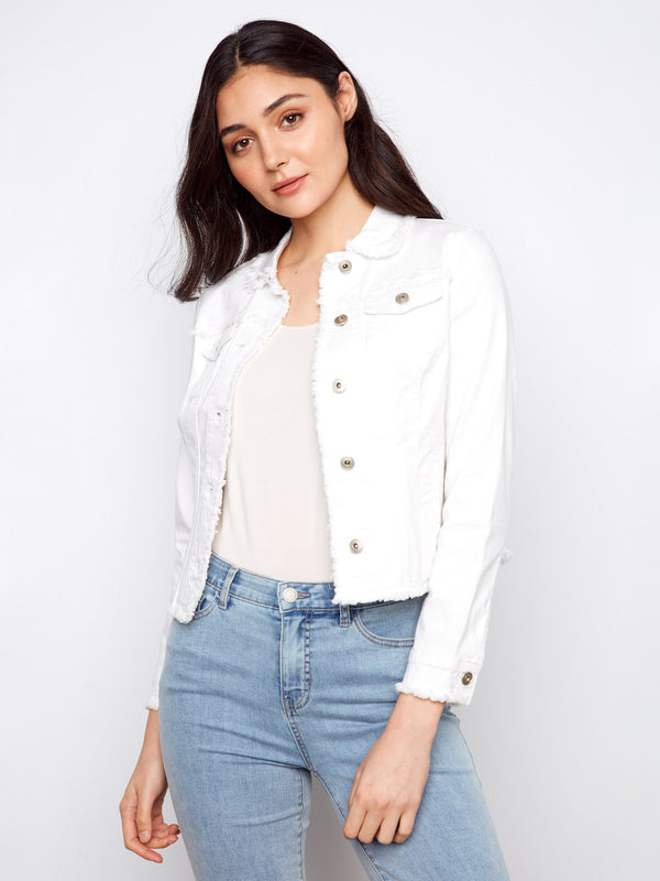 This white denim jacket features functional front patch pockets and stylish frayed edges by Charlie B.