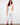 White cropped pants with a regular rise waist and frayed hem, offering a stylish skinny fit by Charlie B.