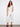 White cropped pants with a regular rise waist and frayed hem, offering a stylish skinny fit by Charlie B.