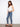 Chic medium blue denim pants featuring a classic five-pocket design and modern frayed hem by Charlie B.