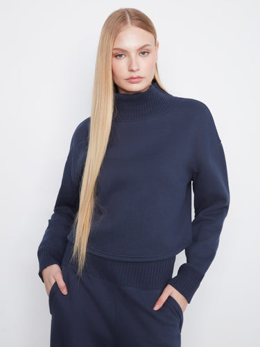 Navy sweater featuring a drop shoulder design, offering a relaxed and comfortable fit. Perfect for casual outings. By Charlie B.