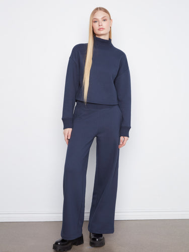 This navy sweater boasts a ribbed mock neck, adding an elegant touch to your outfit. Ideal for layering in cooler weather. By Charlie B.