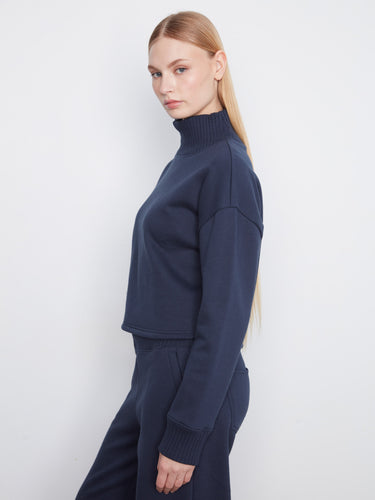 Long sleeves on this navy sweater provide warmth and style, making it a versatile addition to any wardrobe. By Charlie B.