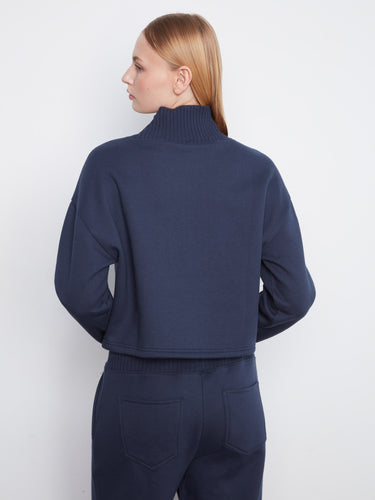 Crafted from a soft cotton blend, this navy sweater ensures comfort while maintaining its chic look throughout the day. By Charlie B.