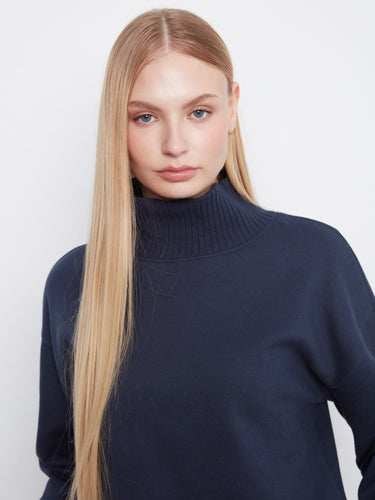 Pair this classic navy sweater with jeans or trousers for an effortlessly chic look that suits any occasion. By Charlie B.