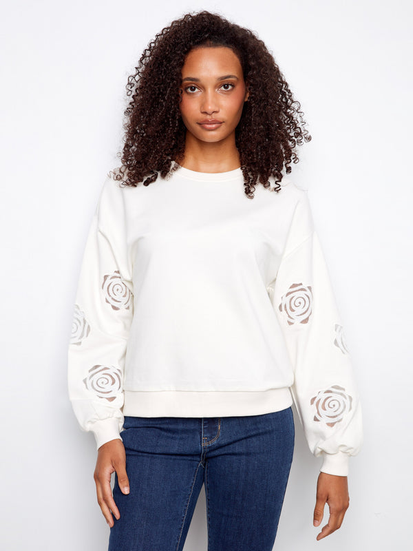 Sweater featuring a crew neckline with intricate sleeve embroidery, offering a stylish touch to your casual look by Charlie B.