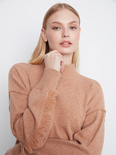Fringe detail on the sleeves adds a playful touch to this cozy sweater. By Charlie B.