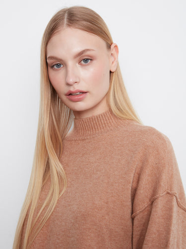 Crafted from soft material, this sweater ensures all-day comfort and style. By Charlie B.