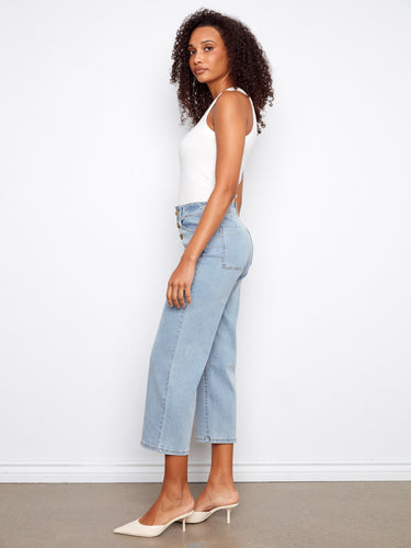 Cropped jeans in light blue showcasing front buttons and stretch fabric for comfort by Charlie B.