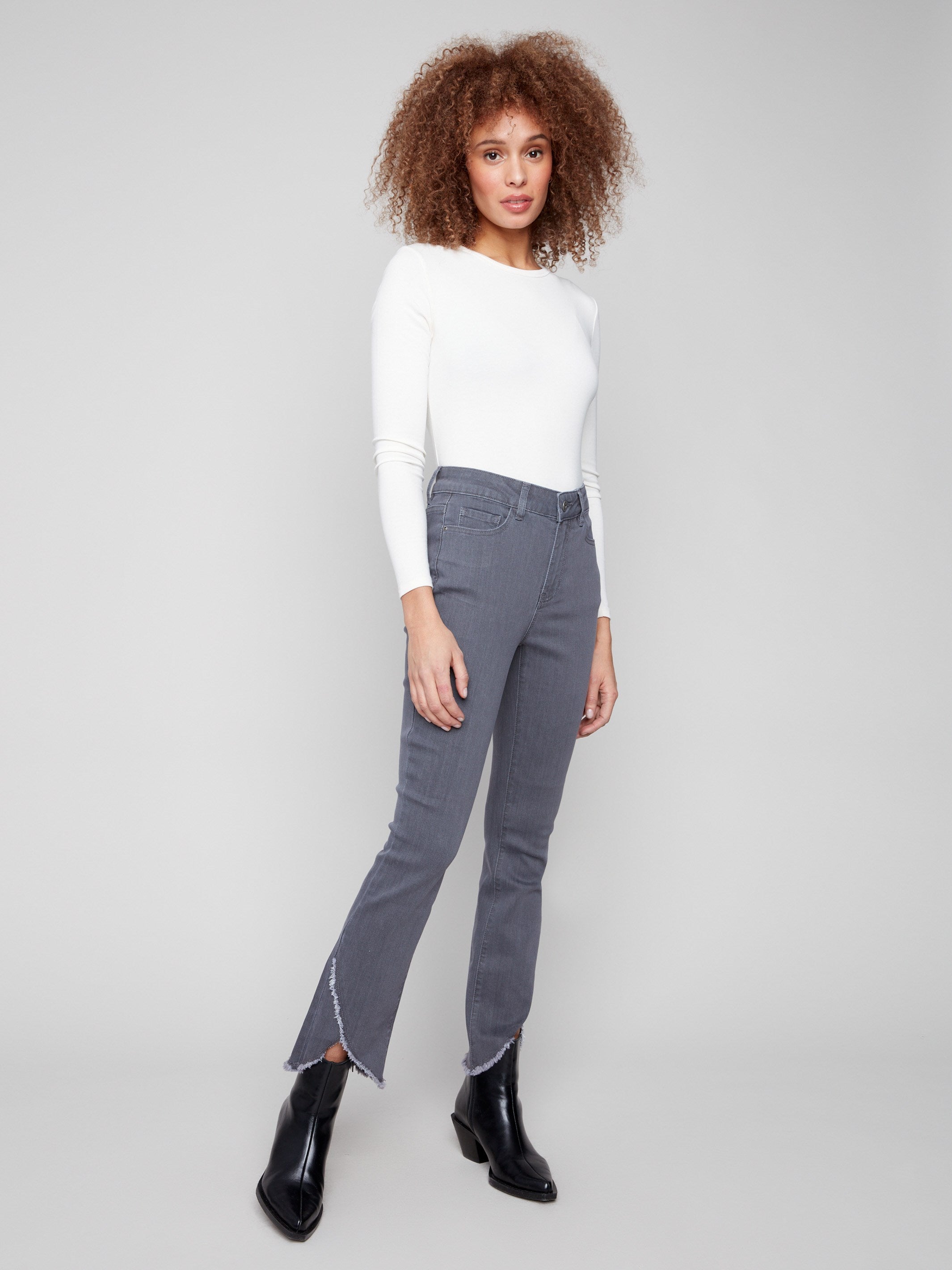 Grey jeans with a bootcut fit and stylish design, featuring a frayed hem for added flair by Charlie B.