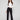 Black pants with a sleek flare fit, paired with a white top, by Charlie B.