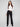 Black pants with a sleek flare fit, paired with a white top, by Charlie B.