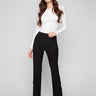 Black pants with a sleek flare fit, paired with a white top, by Charlie B.