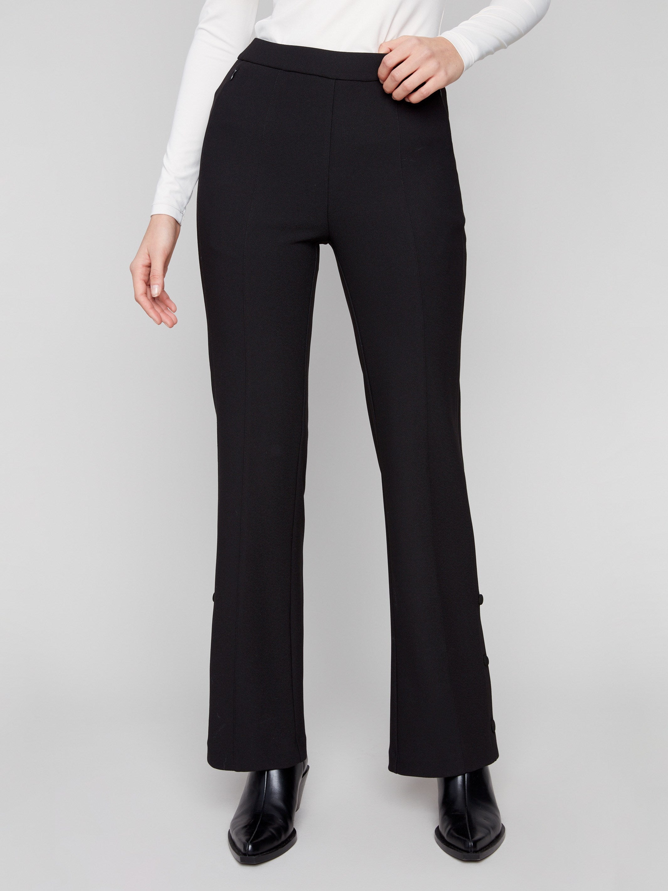 Long length black pants styled elegantly with a white top by Charlie B.