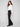 Pants featuring welt pockets and a chic white top ensemble by Charlie B.
