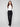 Snap buttons at hem slits on black pants, matched with a white top by Charlie B.