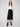 Stylish black skirt showcasing convenient front patch pockets by Charlie B, blending elegance with practicality.