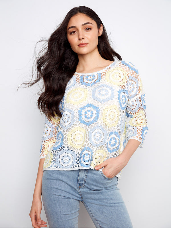 Featuring a crew neckline, this top showcases a beautiful handcrafted crochet design with intricate patterns by Charlie B.