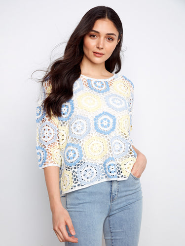 A stunning blend of colors enhances the handcrafted crochet design, making it an eye-catching addition to any wardrobe by Charlie B.