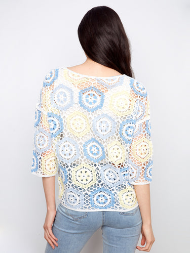 This garment's crew neckline complements the artistic crochet pattern, creating a harmonious and stylish look by Charlie B.
