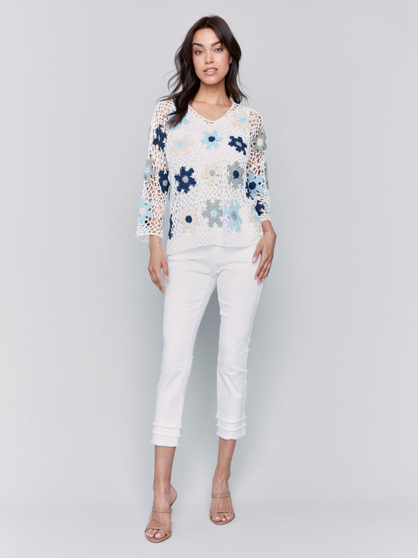 Handcrafted crochet top featuring vibrant floral patterns by Charlie B.