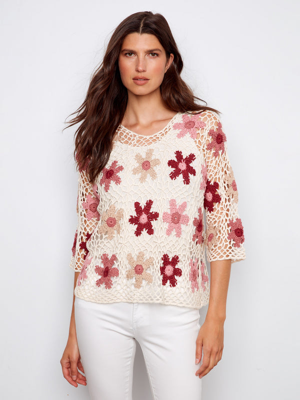 Elegant crochet top featuring a crew neckline and intricate floral patterns, perfect for a chic look by Charlie B.
