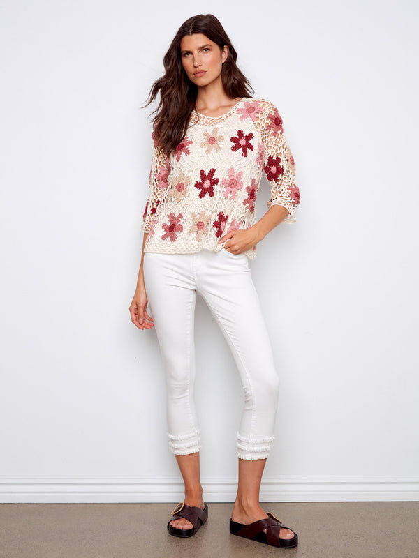Charming crochet top with three-quarter sleeves and detailed floral design, adding elegance to any outfit by Charlie B.