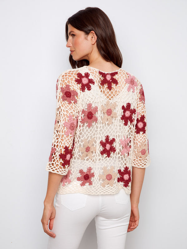 Beautifully designed crochet top showcasing delicate flowers and a comfortable fit for any occasion by Charlie B.