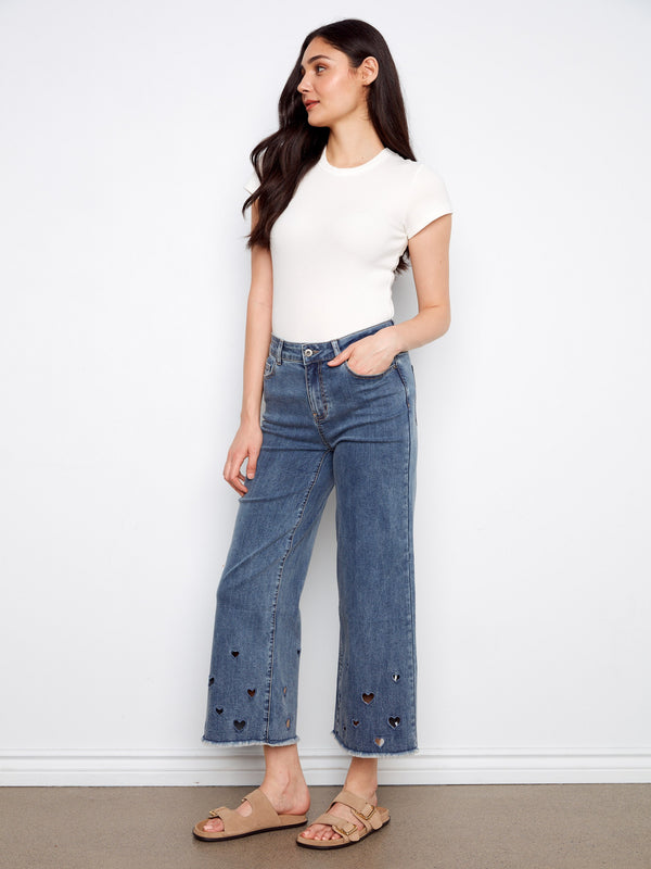 Heart cutouts at the hem add flair to these medium blue jeans with a regular rise by Charlie B.