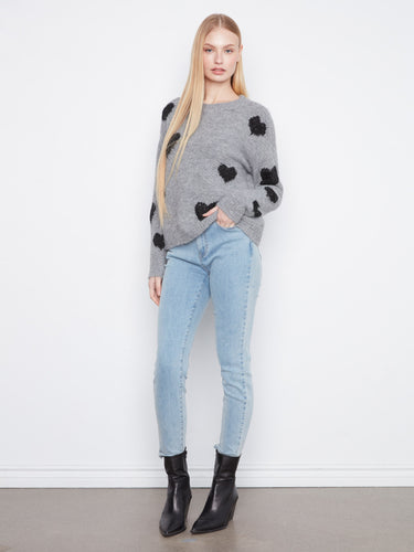 This grey sweater showcases charming black heart embroidery and cozy long sleeves. A stylish piece by Charlie B.