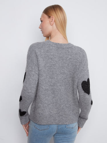 Stay warm in style with this grey sweater's intricate heart embroidery, offering both elegance and charm. By Charlie B.
