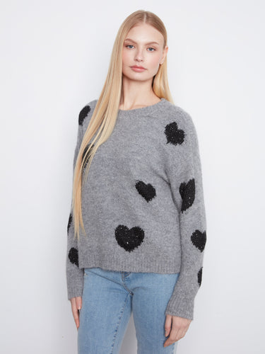Add a touch of love to your wardrobe with this grey sweater featuring beautiful black hearts and a relaxed fit. By Charlie B.