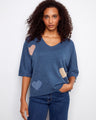 Blue sweater featuring a V-neck design and charming heart patterns, perfect for casual wear by Charlie B.