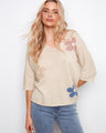 Chic knit top featuring a relaxed fit with elbow sleeves, perfect for casual outings. Finished with Lurex thread for added shimmer by Charlie B.