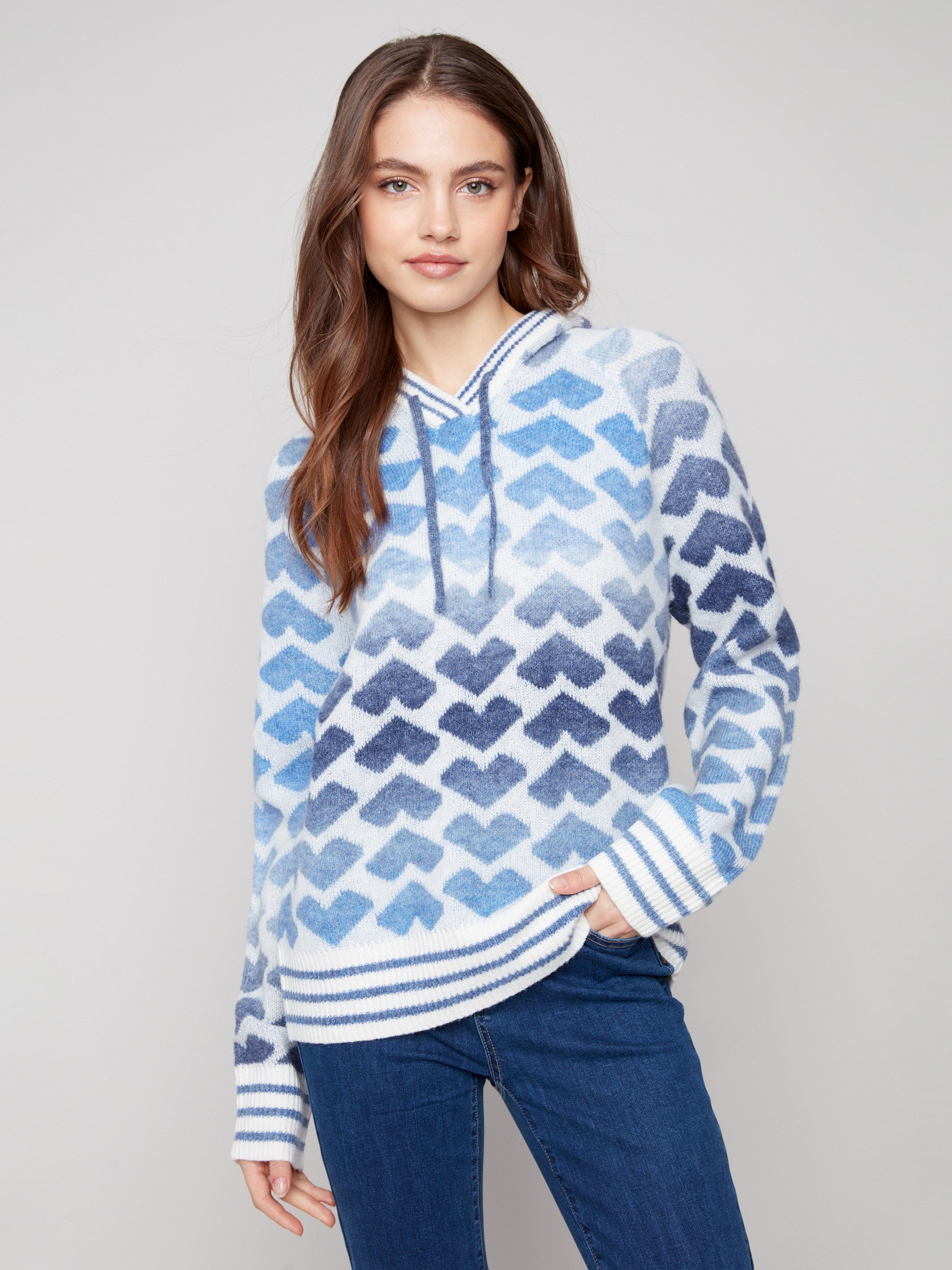 Blue and white sweater featuring a heart pattern with a drawstring hood for added style by Charlie B.
