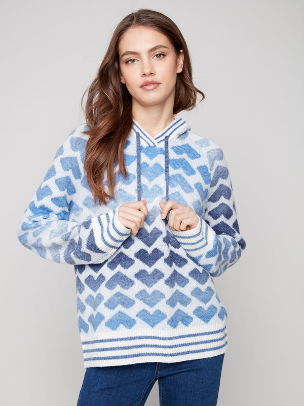 Cozy blue and white heart-patterned sweater featuring an adjustable drawstring hood by Charlie B.