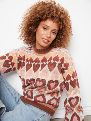 Elegant heart motifs in soft hues make this sweater a standout piece in your wardrobe collection. By Charlie B.
