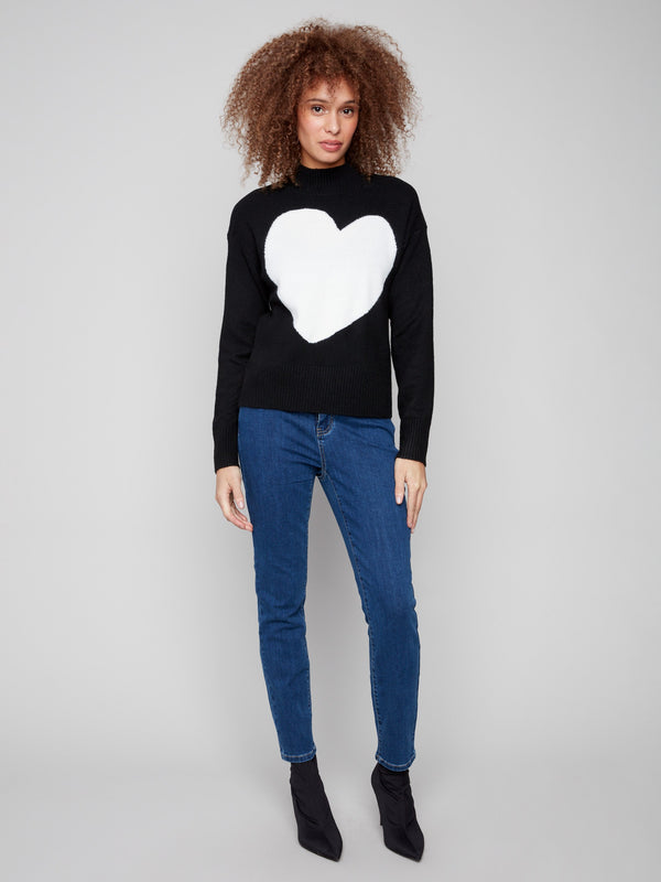 Elegant black sweater showcasing a white heart and featuring a stylish ribbed mock neck design by Charlie B.
