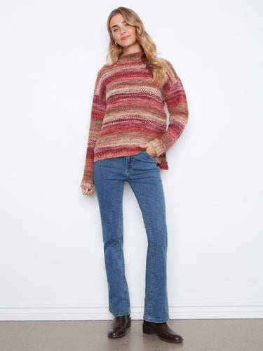 This stylish sweater boasts a high-low hem, adding a modern twist to its classic striped design in rich autumn colors. By Charlie B.