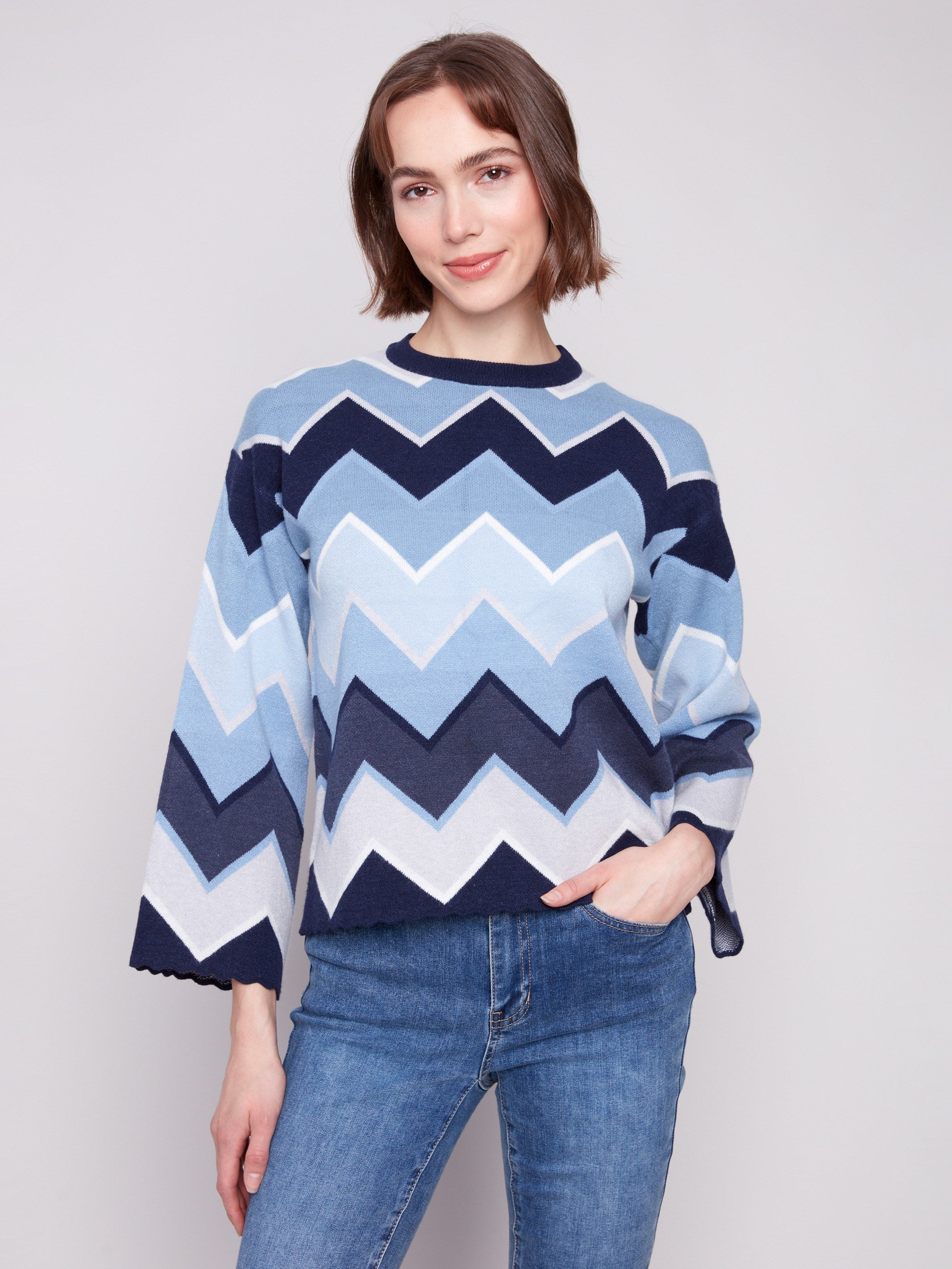 Blue sweater featuring a chevron pattern, paired with casual jeans for a stylish look by Charlie B.