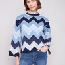 Blue sweater featuring a chevron pattern, paired with casual jeans for a stylish look by Charlie B.