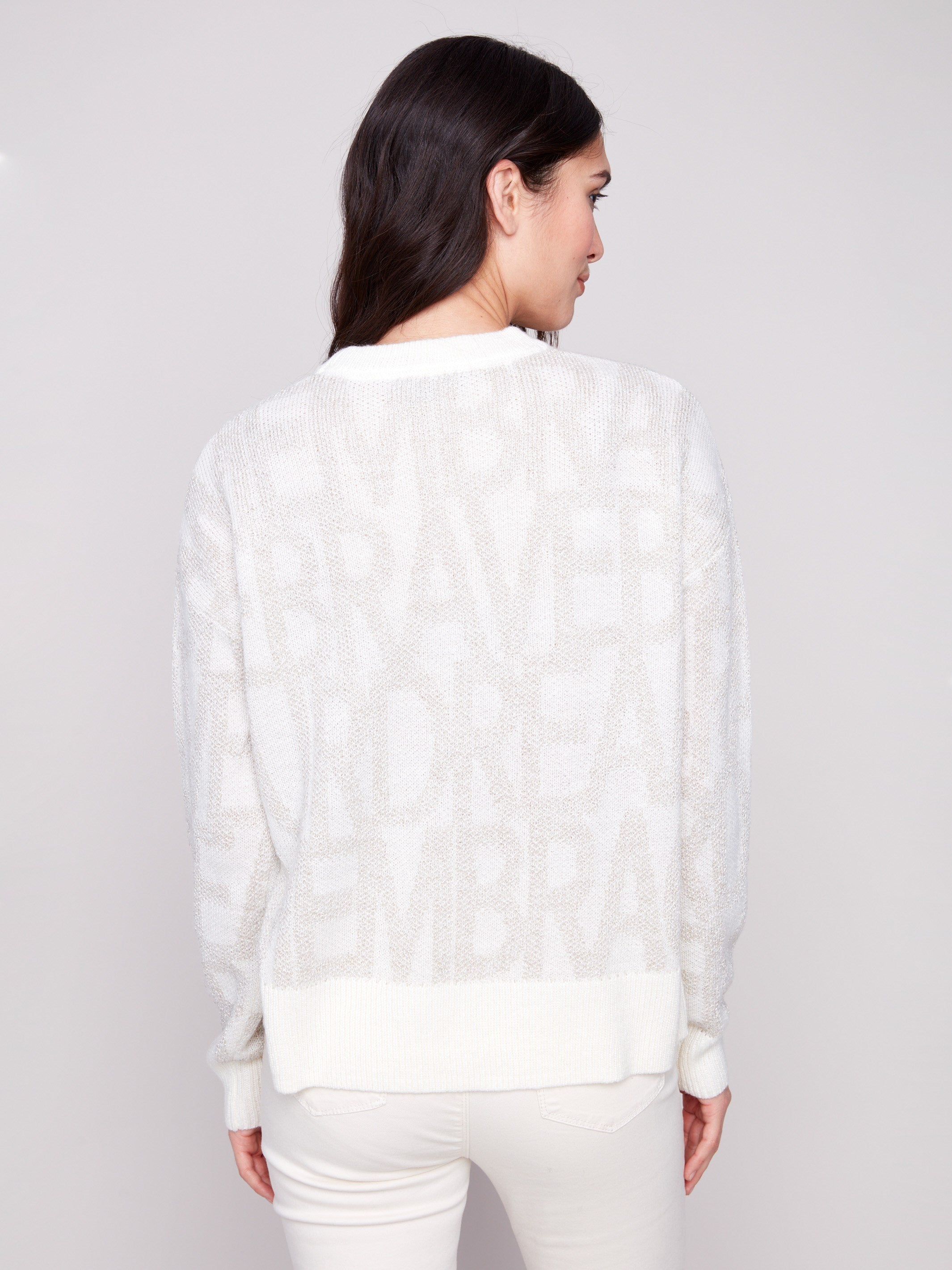 Stylish off-white sweater showcasing subtle tonal text and ribbed detailing for added elegance by Charlie B.