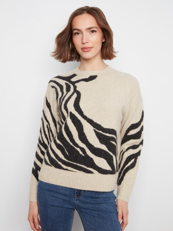 This sweater features a classic crew neck design, offering a timeless and versatile look for any wardrobe. By Charlie B.