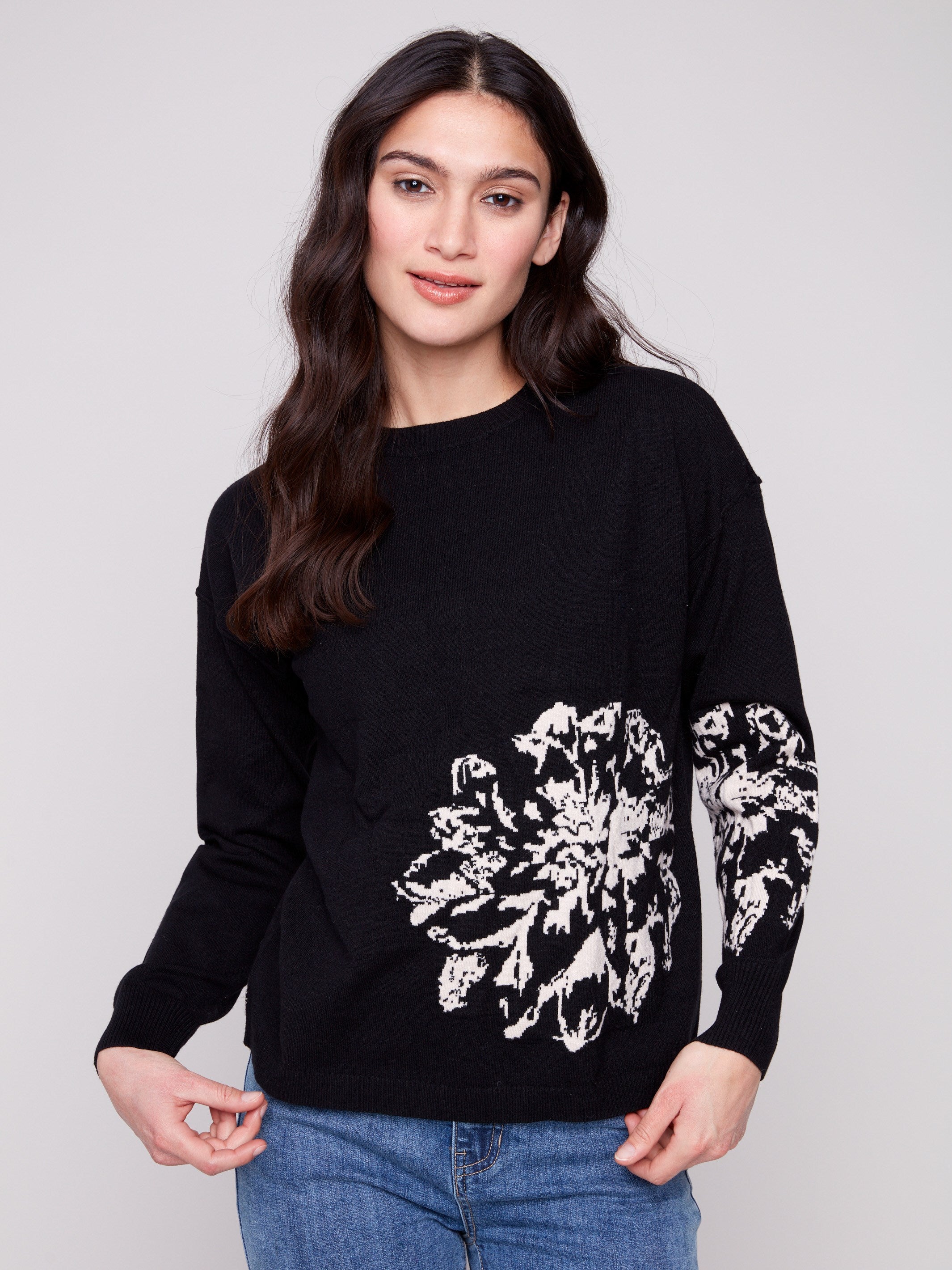 Black sweater with a jacquard floral pattern, showcasing a relaxed fit design and long sleeves for comfort by Charlie B.