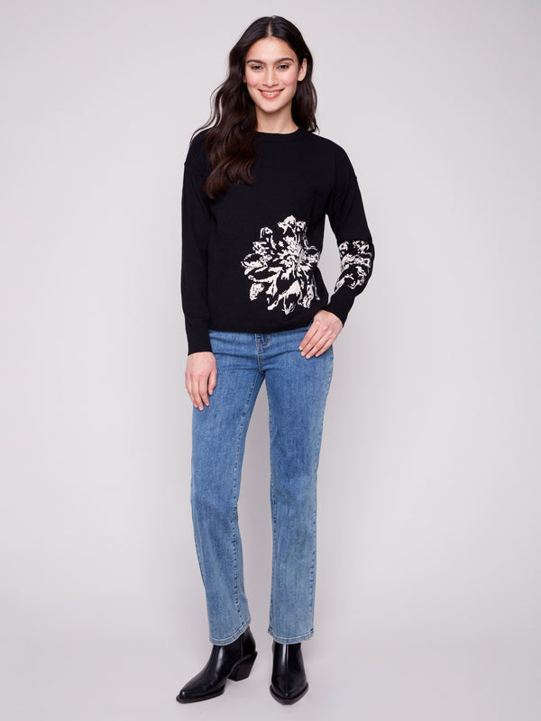 Elegant black sweater adorned with a striking jacquard floral pattern, complete with a crew neck for timeless style by Charlie B.