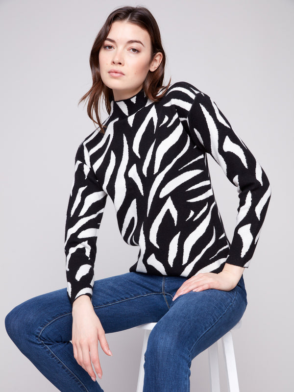 Elegant black and white zebra-patterned sweater with a mock neck, perfect for a sleek silhouette by Charlie B.