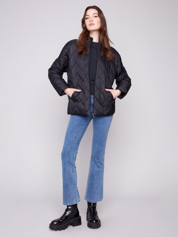 Stylish black jacket showcasing practical welt pockets, ideal for keeping essentials close by Charlie B.