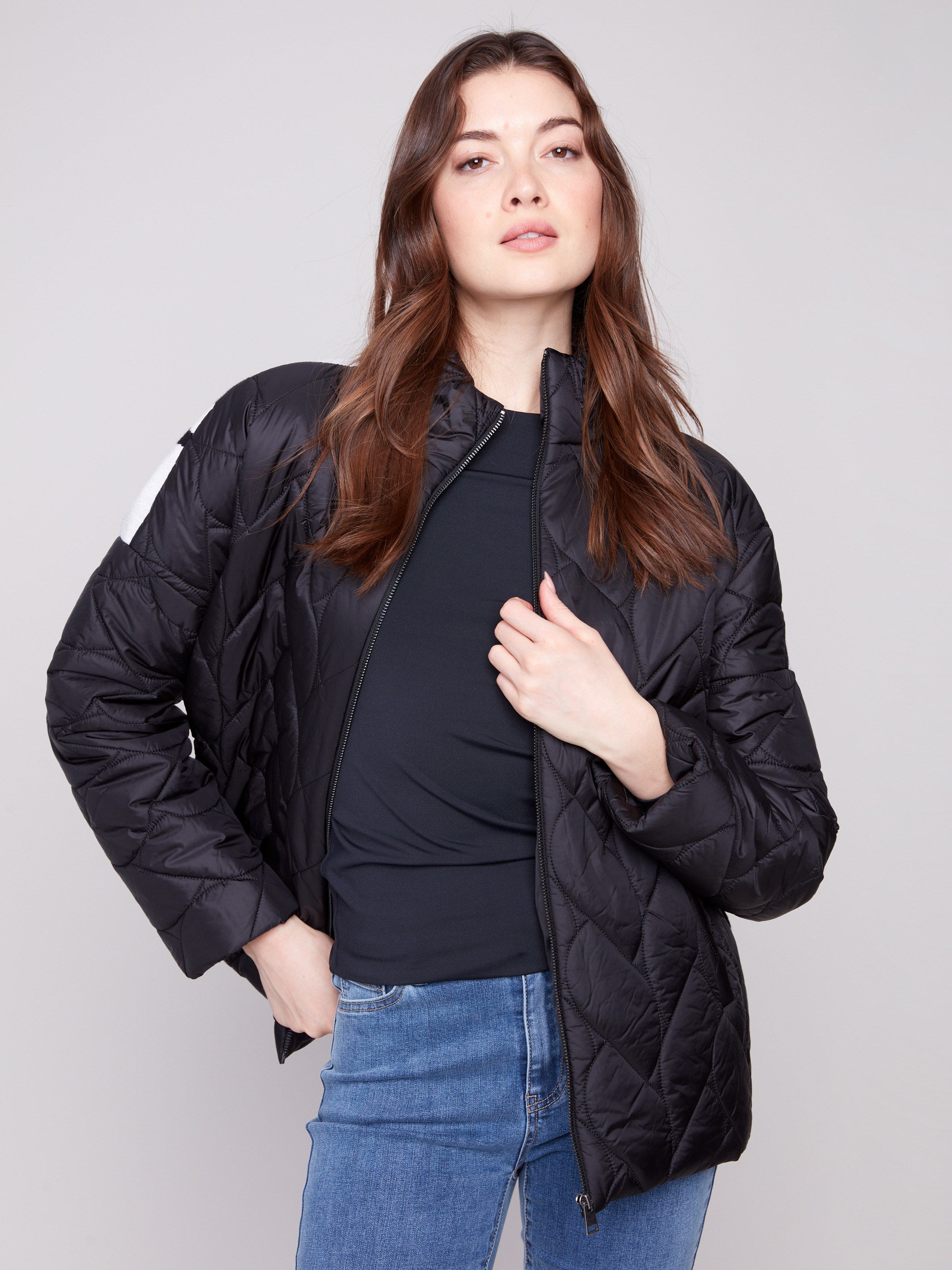 Chic black jacket designed with comfortable quilted fabric, ensuring warmth and style in cooler weather by Charlie B.