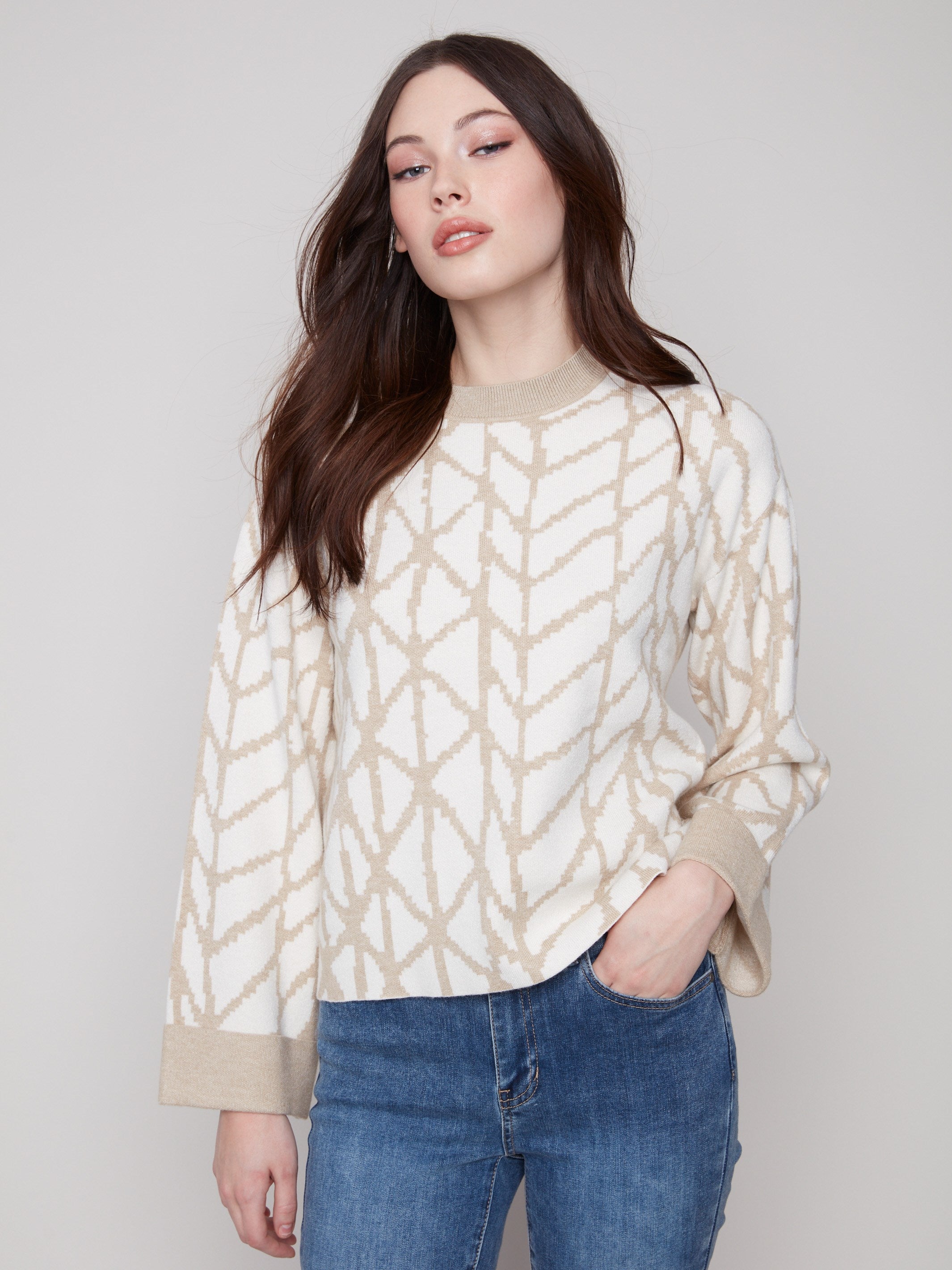 Elegant ecru sweater with a relaxed fit, showcasing a geometric jacquard pattern and stylish folded cuffs by Charlie B.